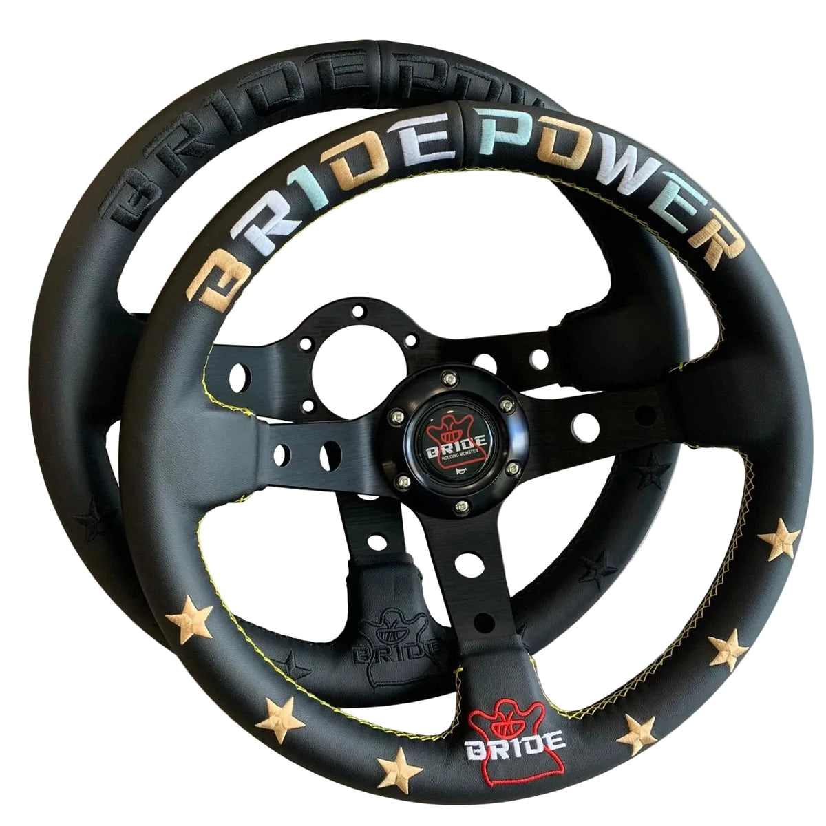 A black racing-style steering wheel with gold star accents and yellow stitching, featuring 'BRIDE POWER' branding in gold, blue, and white lettering on the top rim.