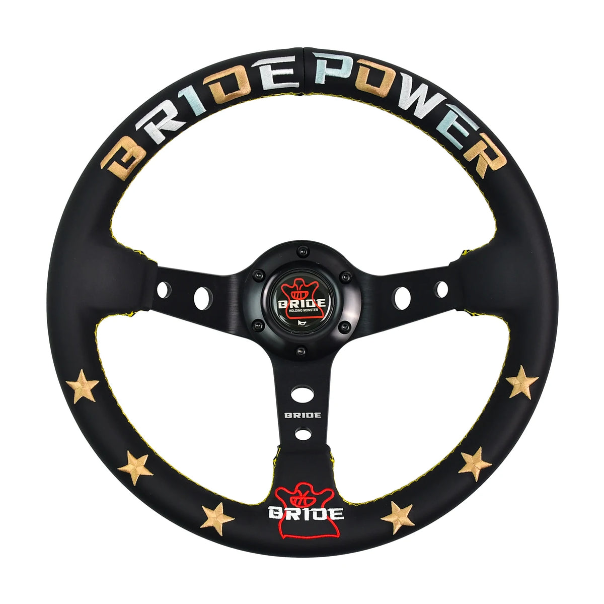 A black three-spoke steering wheel cover by Bride Power, featuring gold stars and gold, blue, and white lettering on the rim, with a red and gold center cap.