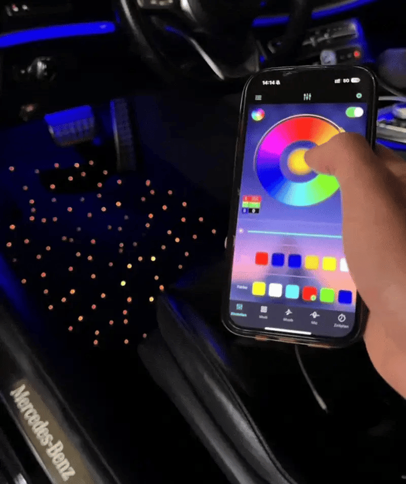 Phone app controlling car interior galaxyglow starlight floor mats lighting with Mercedes-Benz logo visible