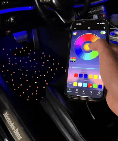 Phone app controlling car interior galaxyglow starlight floor mats lighting with Mercedes-Benz logo visible