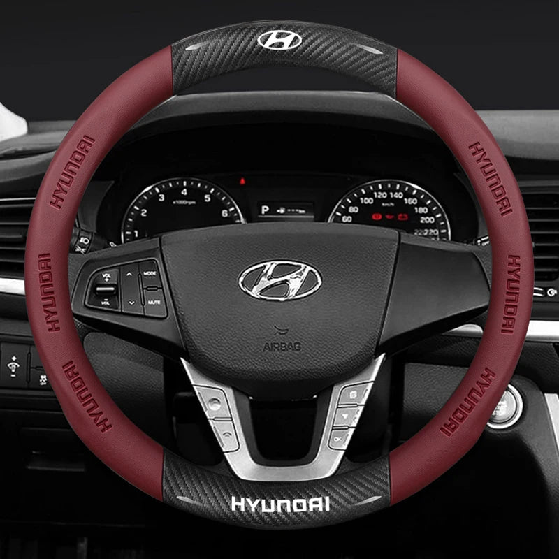 Hyundai steering wheel with red accents and visible brand logo.