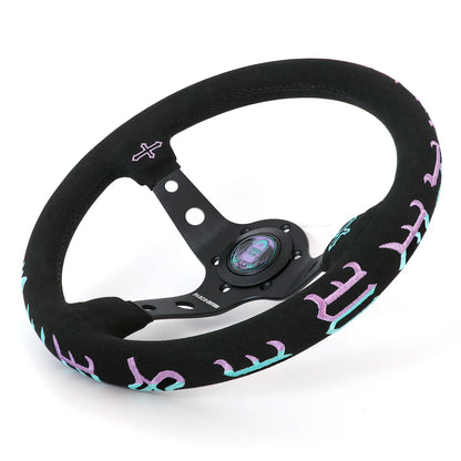 A black racing steering wheel with a textured suede-like rim and purple gothic-style lettering, shown on a white background.
