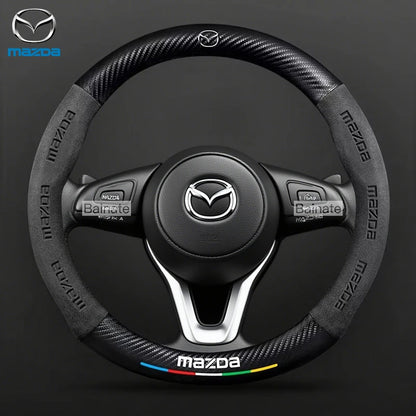 Mazda steering wheel with brand logo on a dark background