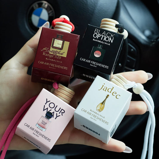 Four car air freshener boxes from different brands held in a hand with a car interior background.
