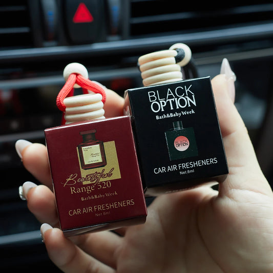 Two car air fresheners, one red and one black, held in a hand with a car interior background.