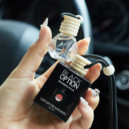 Hand holding a car air freshener with 'Black Option' branding.