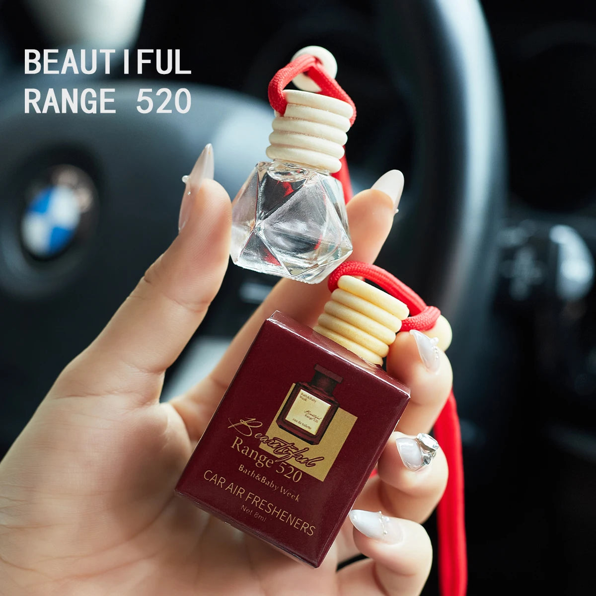 Hand holding a car air freshener with 'Beautiful Range 520' branding in a car interior. Inspired by Baccarat Rouge 540.