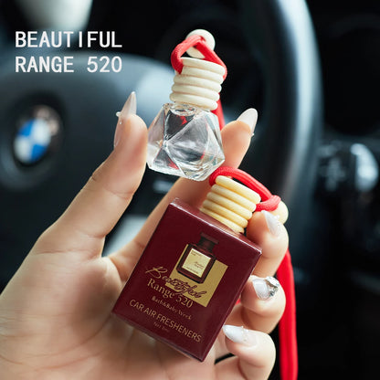 Hand holding a car air freshener with 'Beautiful Range 520' branding in a car interior. Inspired by Baccarat Rouge 540.