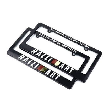 Two black licence plate frames with white text reading 'RALLI ART' and 'THE SPIRIT OF COMPETITION'.
