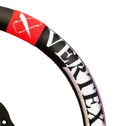 Close-up of a steering wheel with 'Vertex' branding on a red and gray checkered background.